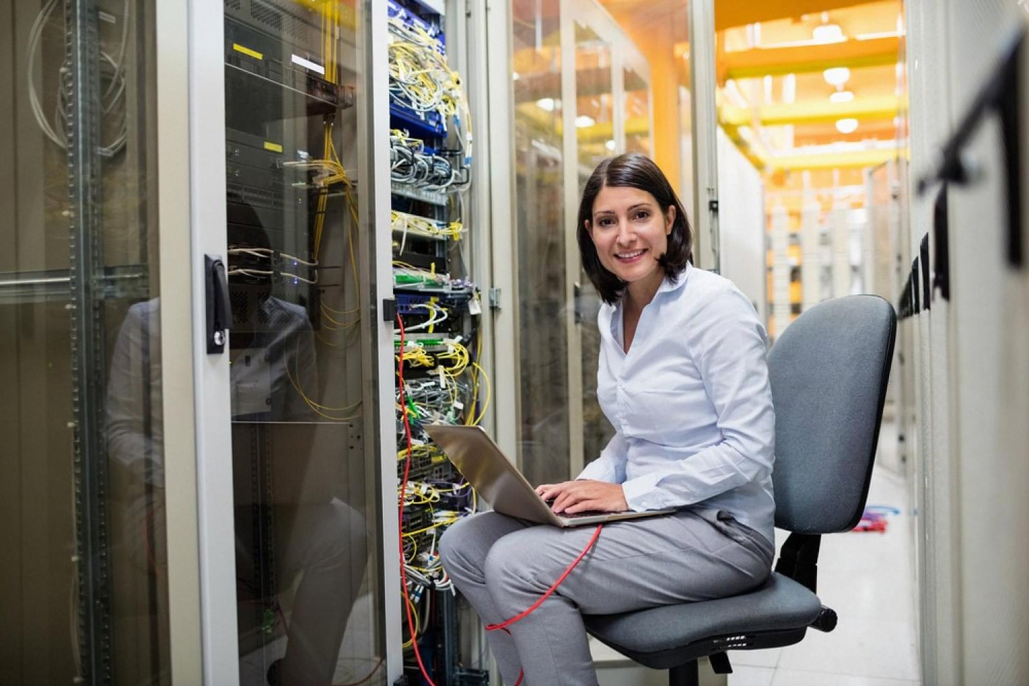 Managed IT specialist working on a laptop inside a UAE data centre server room