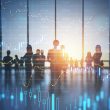 Silhouettes of business executives against a stock chart, illustrating background screening as a risk management tool in the UAE