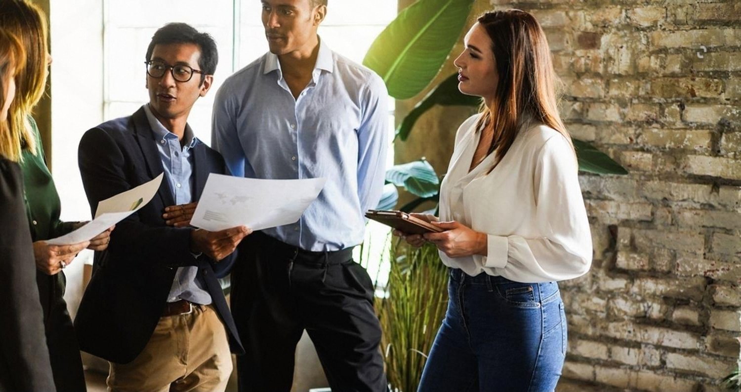 Business professionals reviewing documents during an executive vetting and due diligence meeting