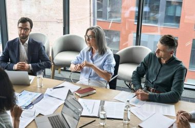 Board members discussing internal policies in a UAE office meeting room