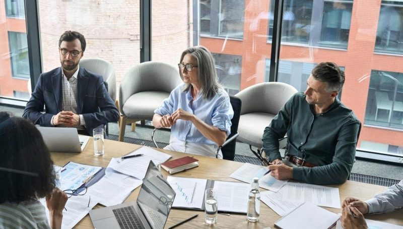 Board members discussing internal policies in a UAE office meeting room