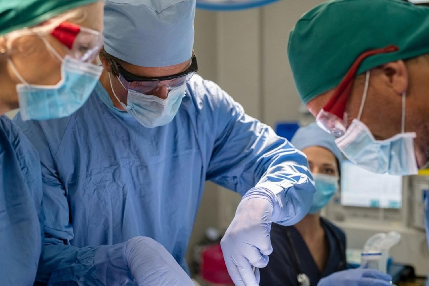 Surgeons performing keyhole laparoscopic hernia repair with precision instruments