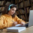 Medical trainee studying arterial blood gas interpretation with headphones and notes