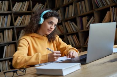 Medical trainee studying arterial blood gas interpretation with headphones and notes